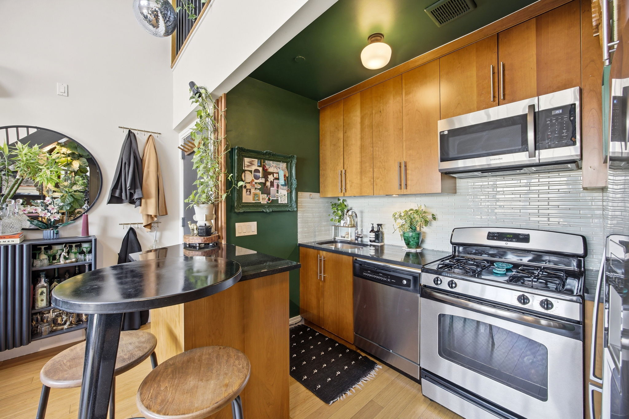 175 12th Street, Unit 4B Brooklyn, NY 11215 - Photo 9 of 27 a kitchen with stainless steel appliances granite countertop a sink a stove and a wooden cabinets