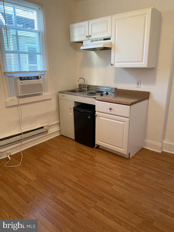 a kitchen with granite countertop a stove and cabinets