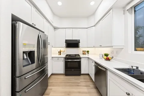 a kitchen with a sink stove and refrigerator