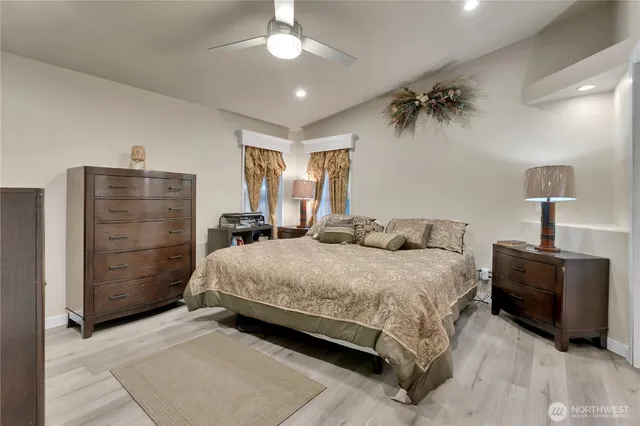 a bedroom with a bed and a chandelier