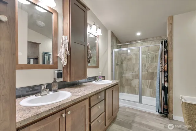 a bathroom with a granite countertop sink mirror and double