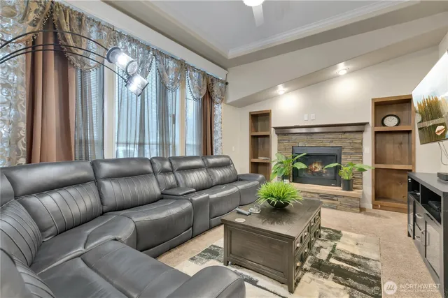 a living room with furniture a fireplace and a chandelier