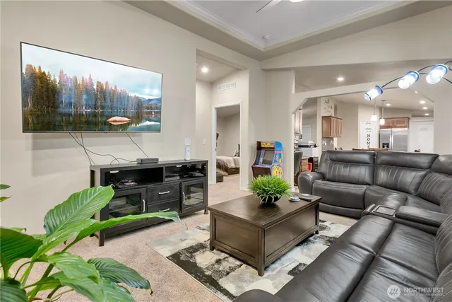 a living room with furniture potted plant and a view of kitchen