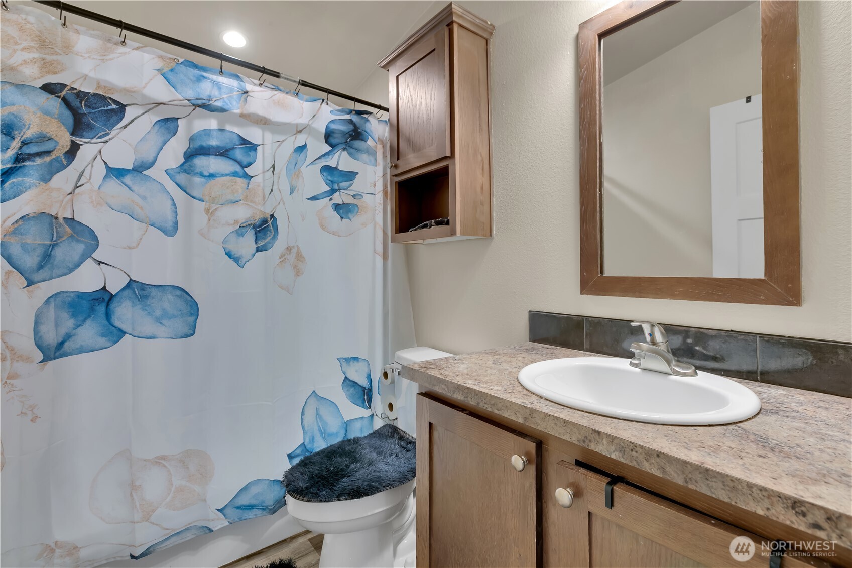 439 Duterrow Road Southeast, Unit 14 Olympia, WA 98513 - Photo 20 of 25 a bathroom with a granite countertop sink a toilet and a mirror