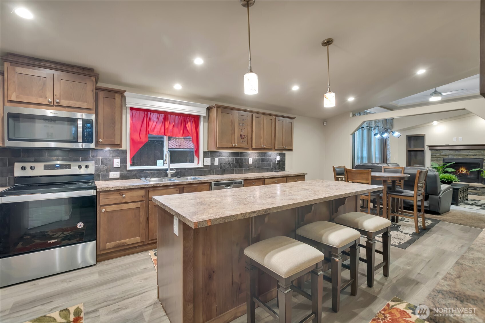 439 Duterrow Road Southeast, Unit 14 Olympia, WA 98513 - Photo 6 of 25 a kitchen with stainless steel appliances granite countertop a stove top oven a refrigerator a sink and chairs