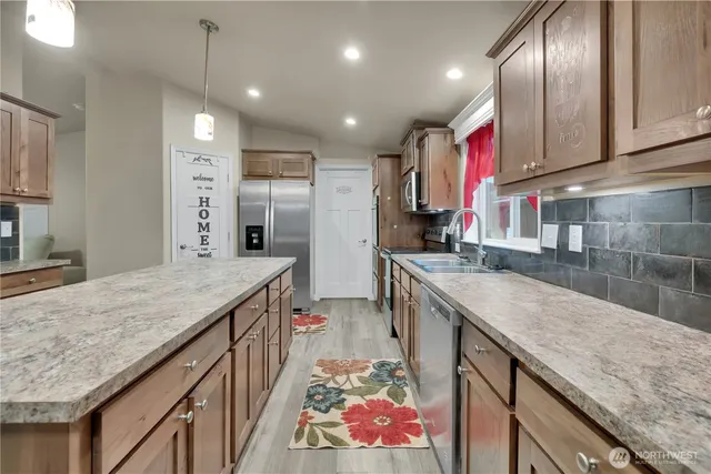 a kitchen with stainless steel appliances granite countertop plenty wooden cabinets