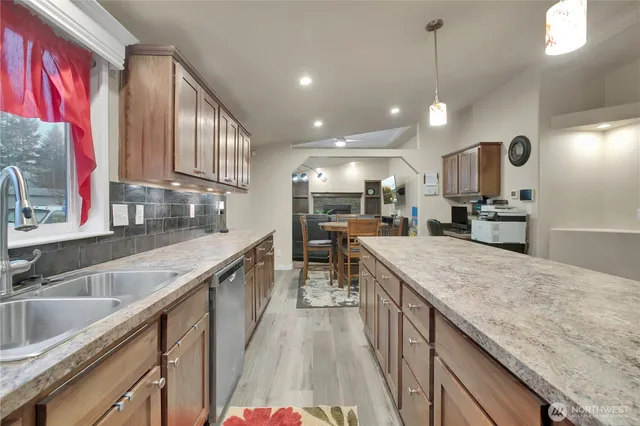 a kitchen with a sink stove and cabinets
