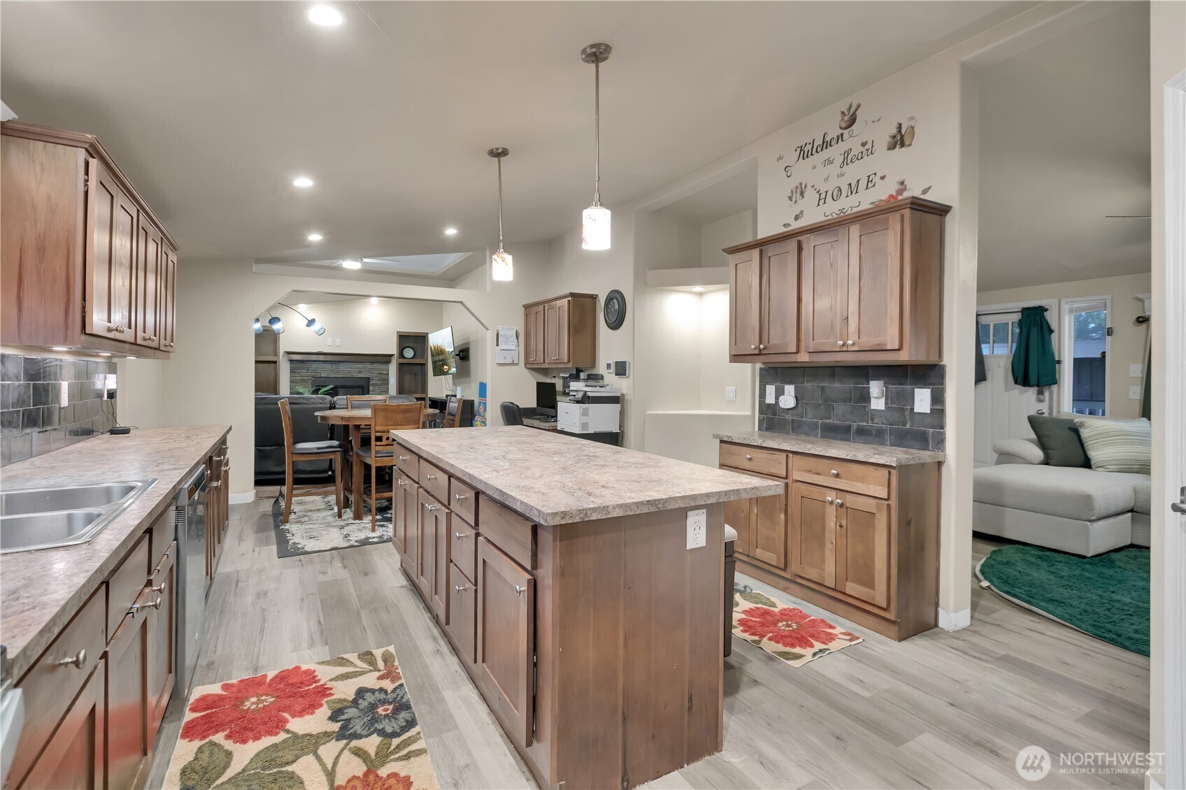 439 Duterrow Road Southeast, Unit 14 Olympia, WA 98513 - Photo 10 of 25 a kitchen with kitchen island granite countertop lots of wooden cabinets a sink a stove and a center island