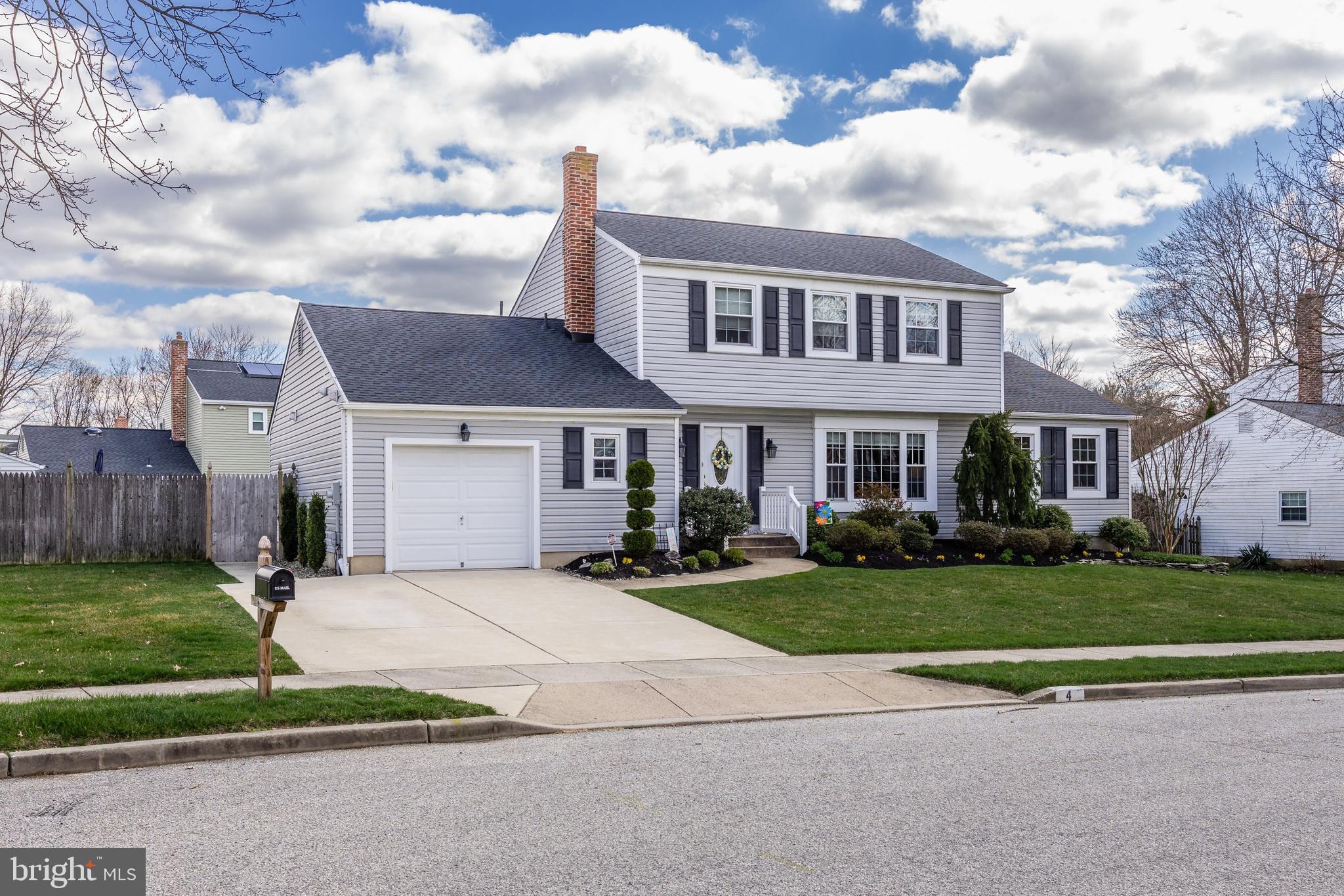 4 Utica Road Marlton, NJ 08053 - Photo 2 of 42 a front view of a house with a garden and pathway