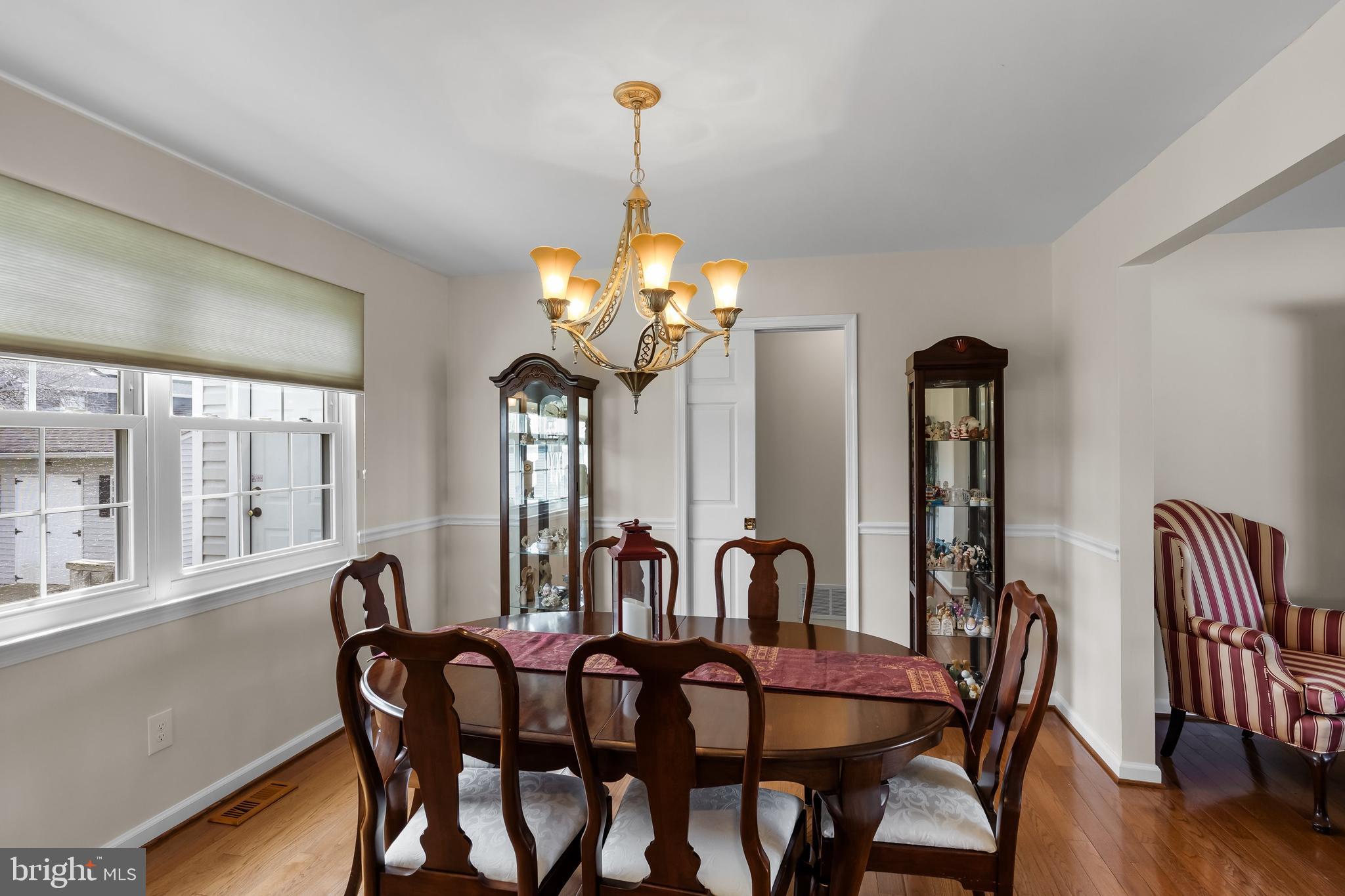 4 Utica Road Marlton, NJ 08053 - Photo 10 of 42 a dining room with furniture a chandelier and wooden floor