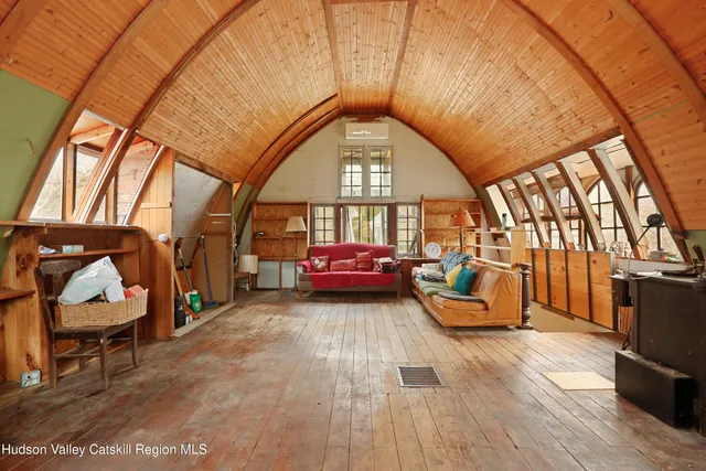 a living room with furniture a couch and large window