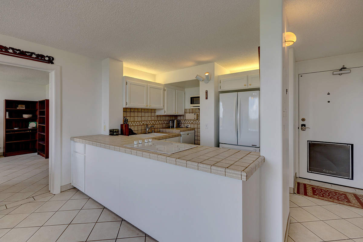 101 Aupuni Street, Unit 802 Hilo, HI 96720 - Photo 11 of 29 a view of kitchen with refrigerator stove and cabinets
