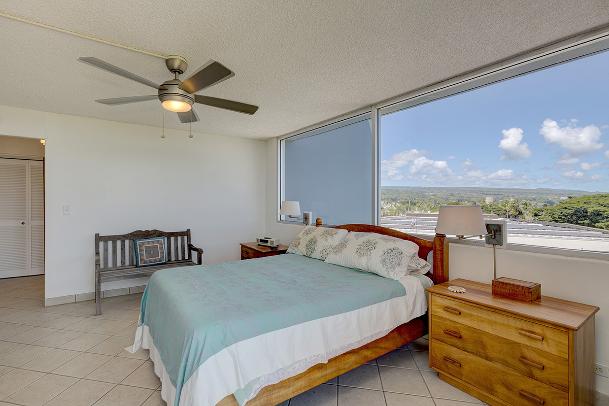 101 Aupuni Street, Unit 802 Hilo, HI 96720 - Photo 3 of 29 a bedroom with a bed and ceiling fan