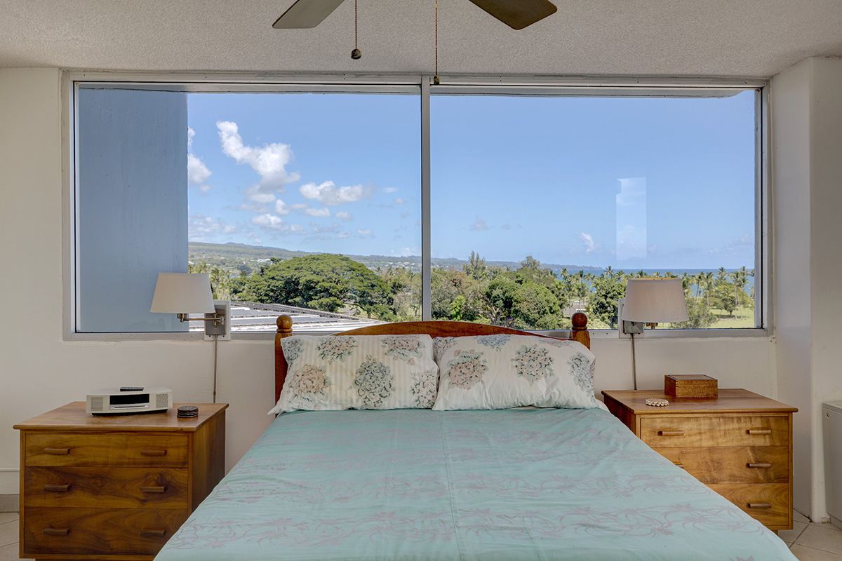 101 Aupuni Street, Unit 802 Hilo, HI 96720 - Photo 8 of 29 a living room with furniture and a floor to ceiling window
