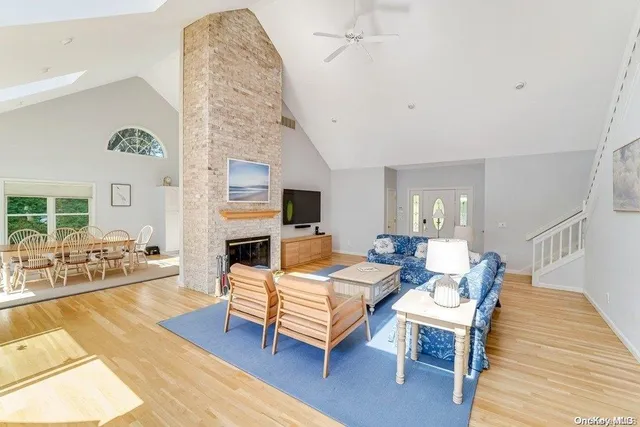 a living room with fireplace furniture and a wooden floor