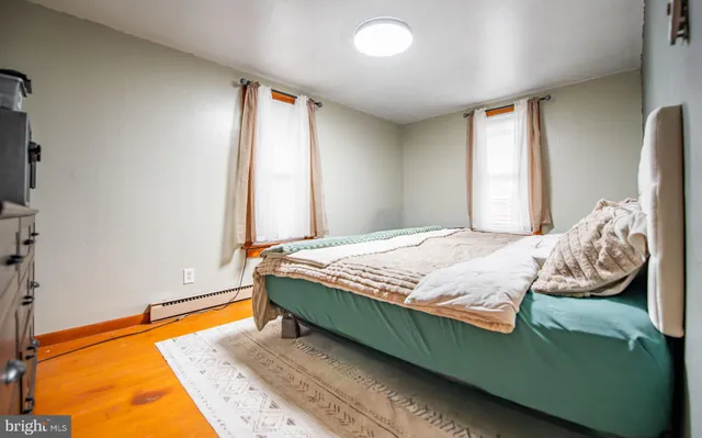 a view of a bedroom with furniture and a window