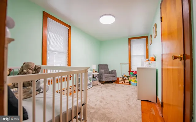 a bedroom with two beds and a window