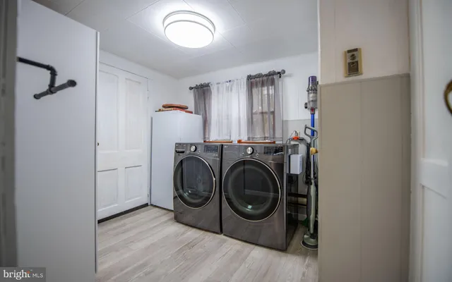 a kitchen with refrigerator and cabinets