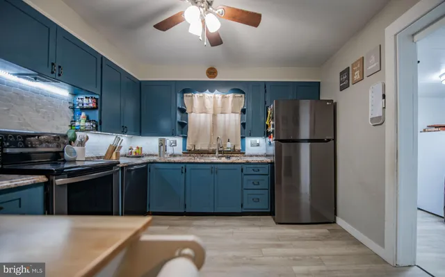 a kitchen with stainless steel appliances granite countertop a refrigerator stove a sink dishwasher and a refrigerator