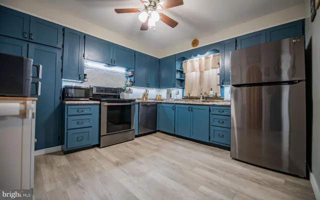 a kitchen with stainless steel appliances granite countertop a stove a sink dishwasher a refrigerator and a refrigerator