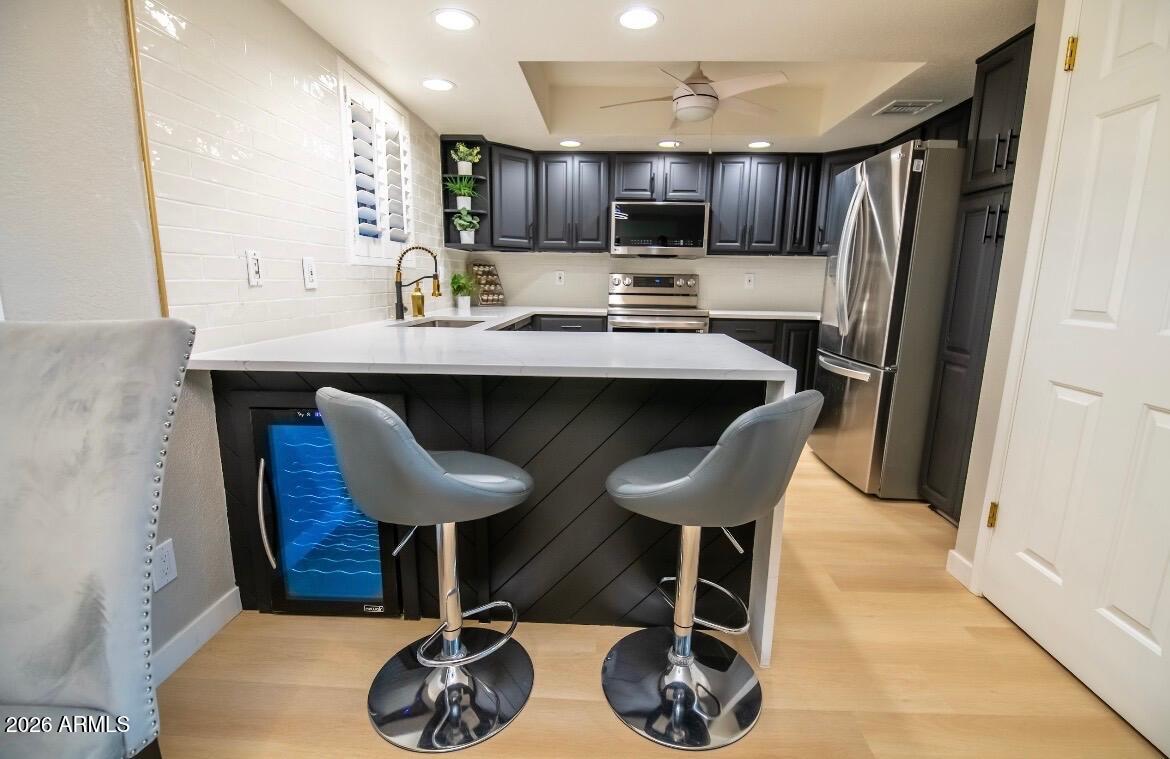 4303 East Cactus Road, Unit 128 Phoenix, AZ 85032 - Photo 16 of 39 a kitchen with stainless steel appliances granite countertop a sink a stove a refrigerator and cabinets