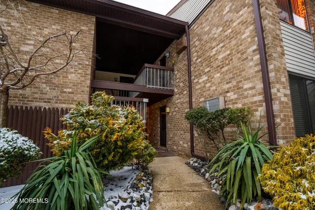 a view of a pathway of a house with a flower garden
