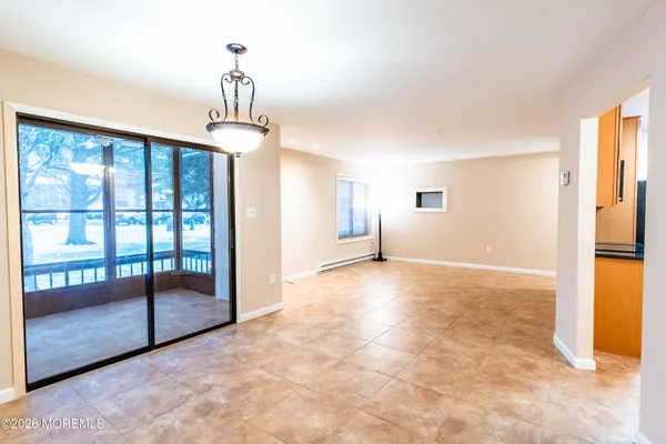 a view of empty room with floor to ceiling windows