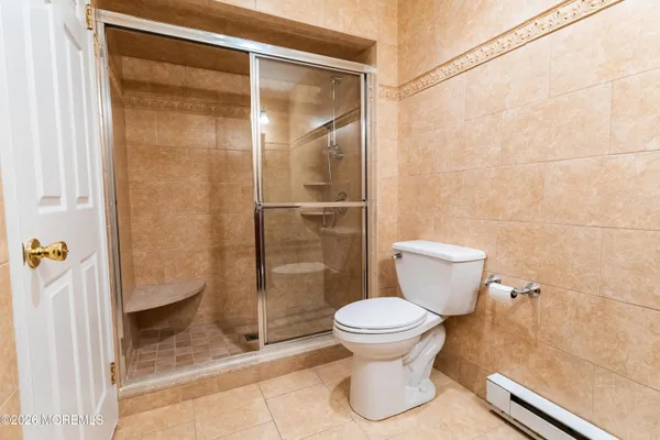 a bathroom with a toilet and a shower