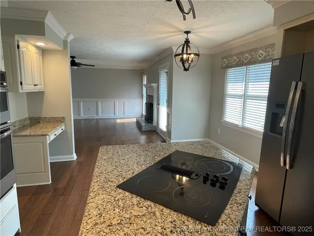 a kitchen with a stove a sink and a refrigerator