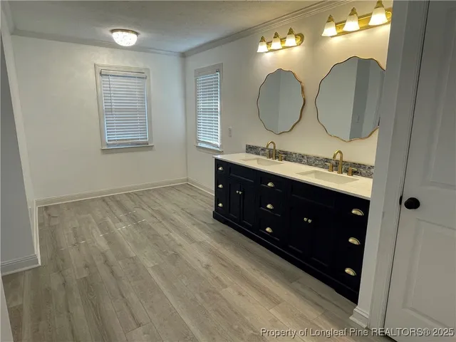 a bathroom with a double vanity sink and a mirror