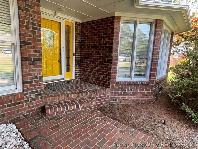 a view of a brick house with a large window