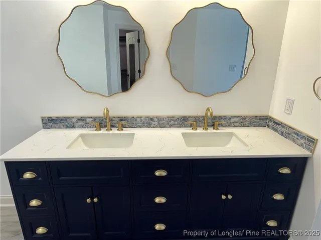 a bathroom with a double vanity sink and mirror