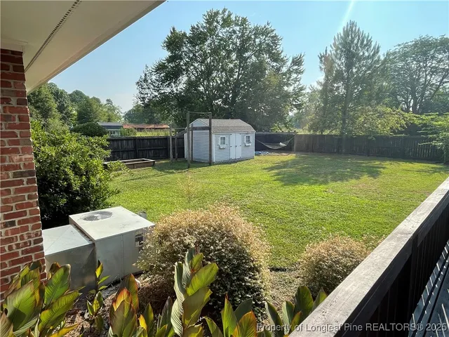 a view of a backyard with plants and lake view
