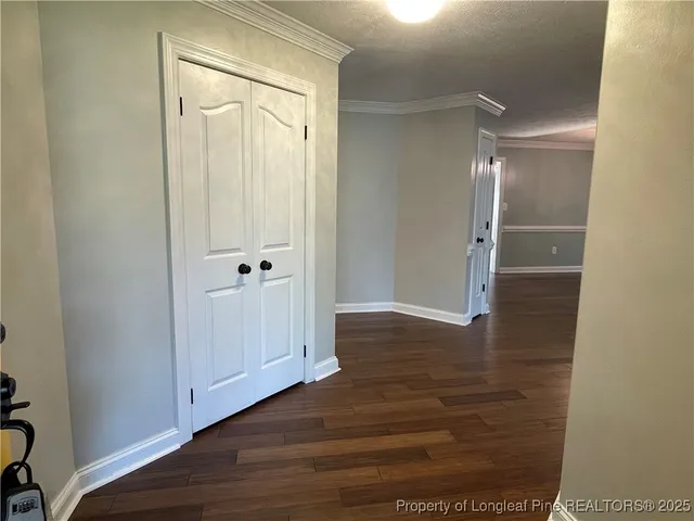 a view of an empty room with wooden floor