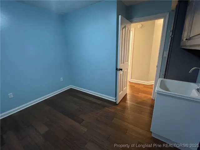 a view of a room with wooden floor and a window