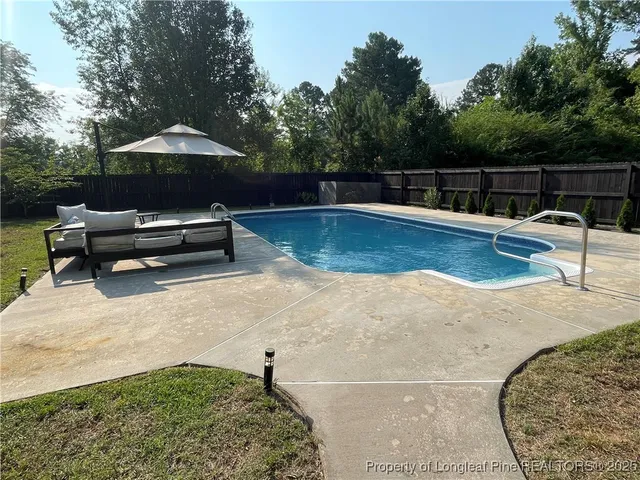 a view of a swimming pool with a lounge chair