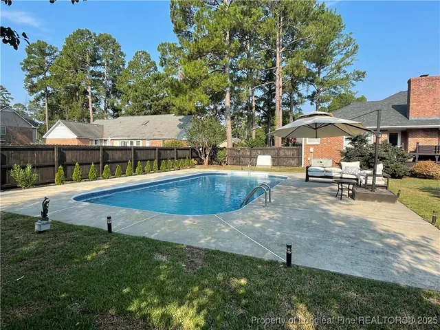 swimming pool view with a outdoor seating