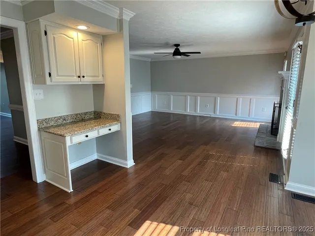 a room with wooden floor and electronic appliances