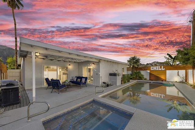 a view of a swimming pool with seating area
