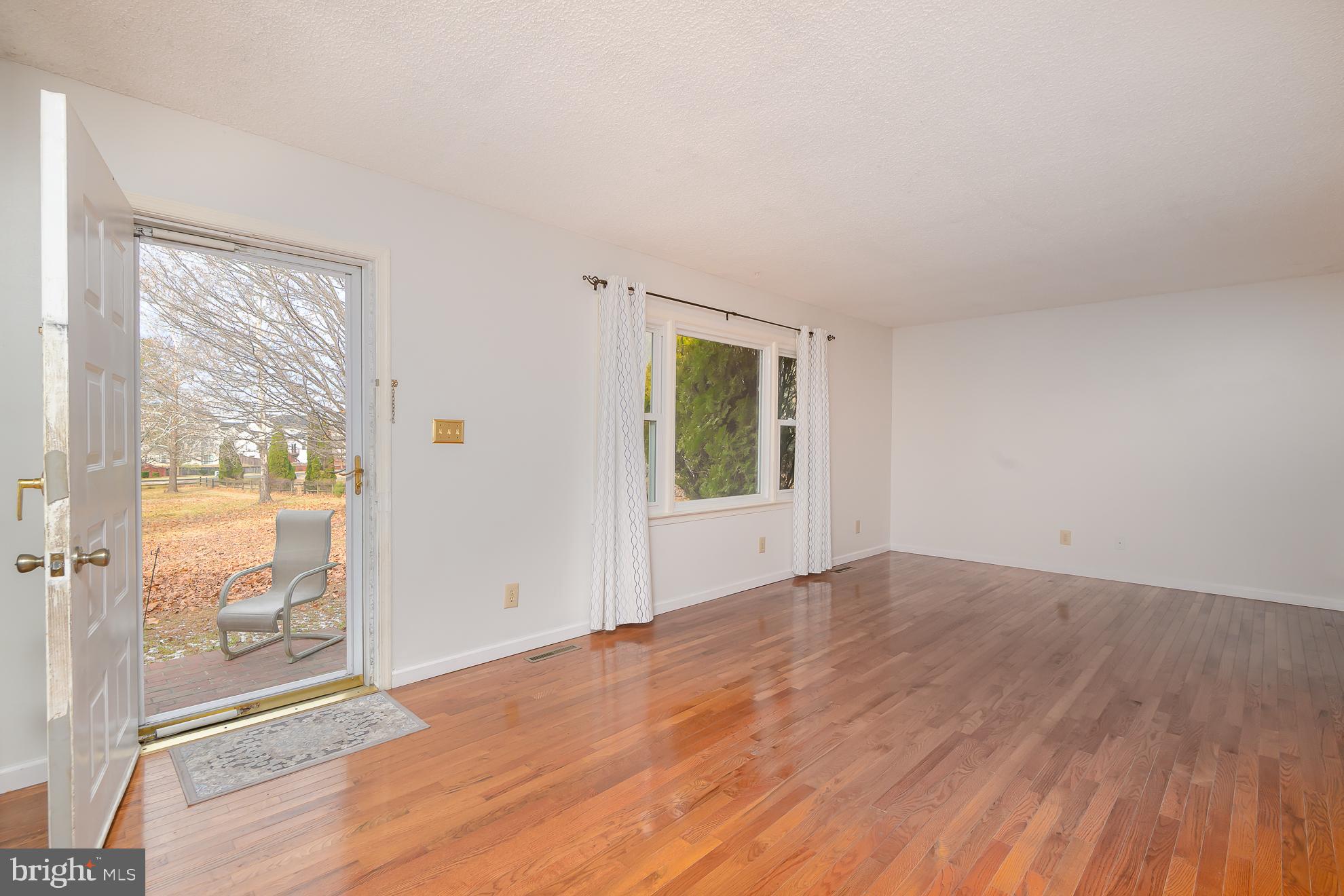 Bright Living Room with hardwood floors.