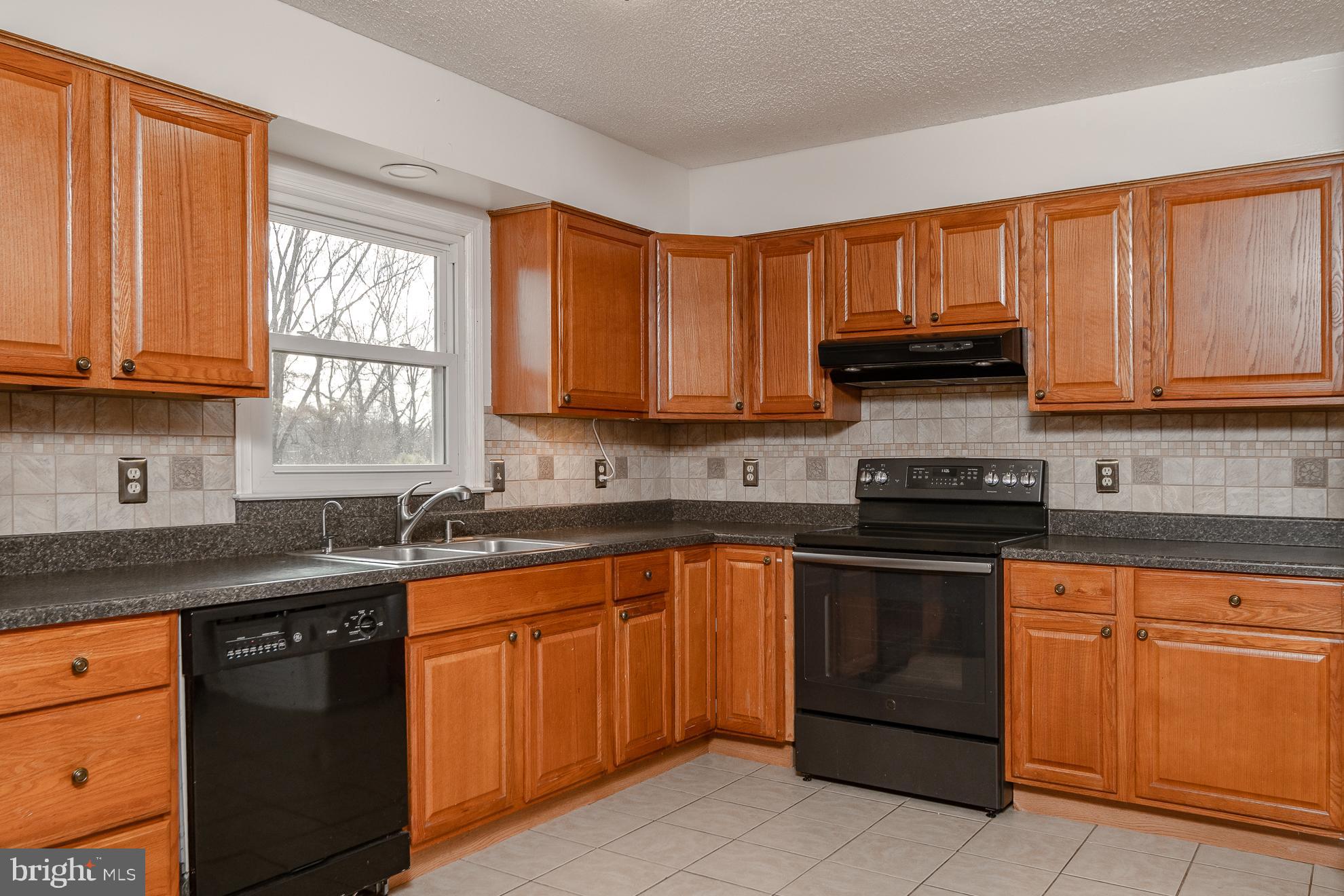 50 Olde Concord Road Stafford, VA 22554 - Photo 7 of 41 Kitchen with warm wood cabinetry & tile backsplash