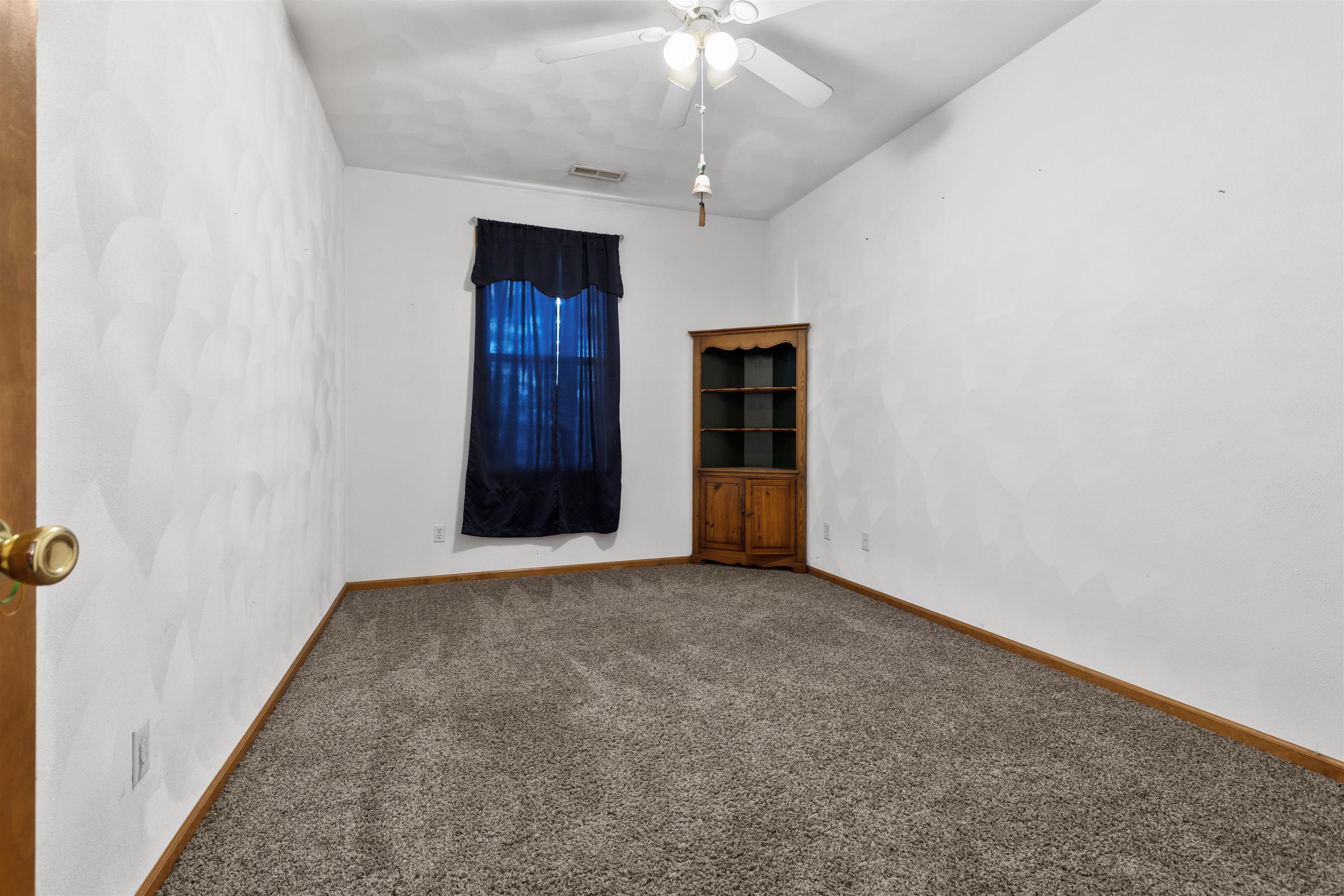10149 Monarch Road, Unit 3 Roscoe, IL 61073 - Photo 12 of 13 an empty room with a fireplace and chandelier fan