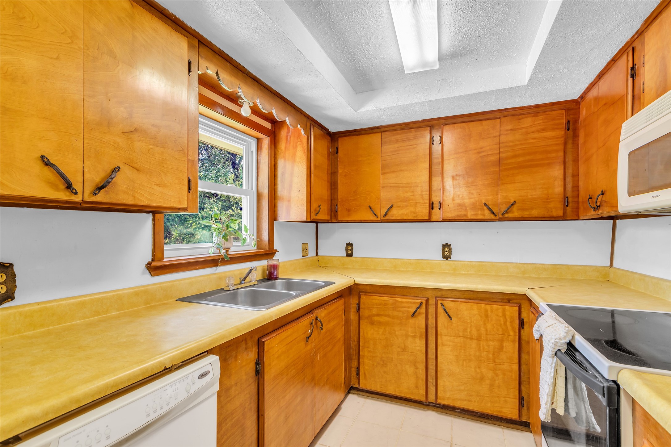 302 Channelview Drive Anahuac, TX 77514 - Photo 12 of 35 a kitchen with a sink and a window