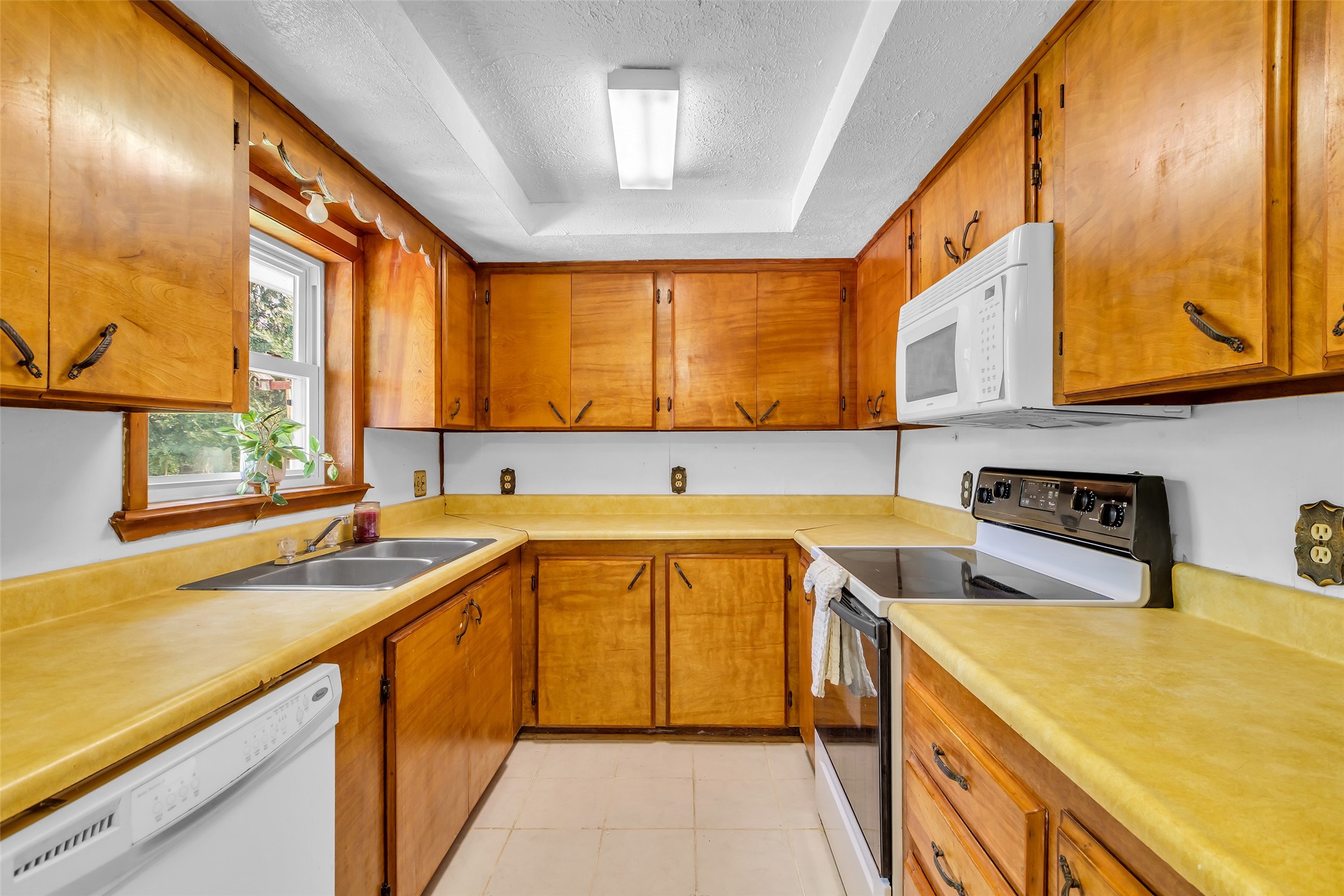 302 Channelview Drive Anahuac, TX 77514 - Photo 13 of 35 a kitchen with a sink a stove and cabinets