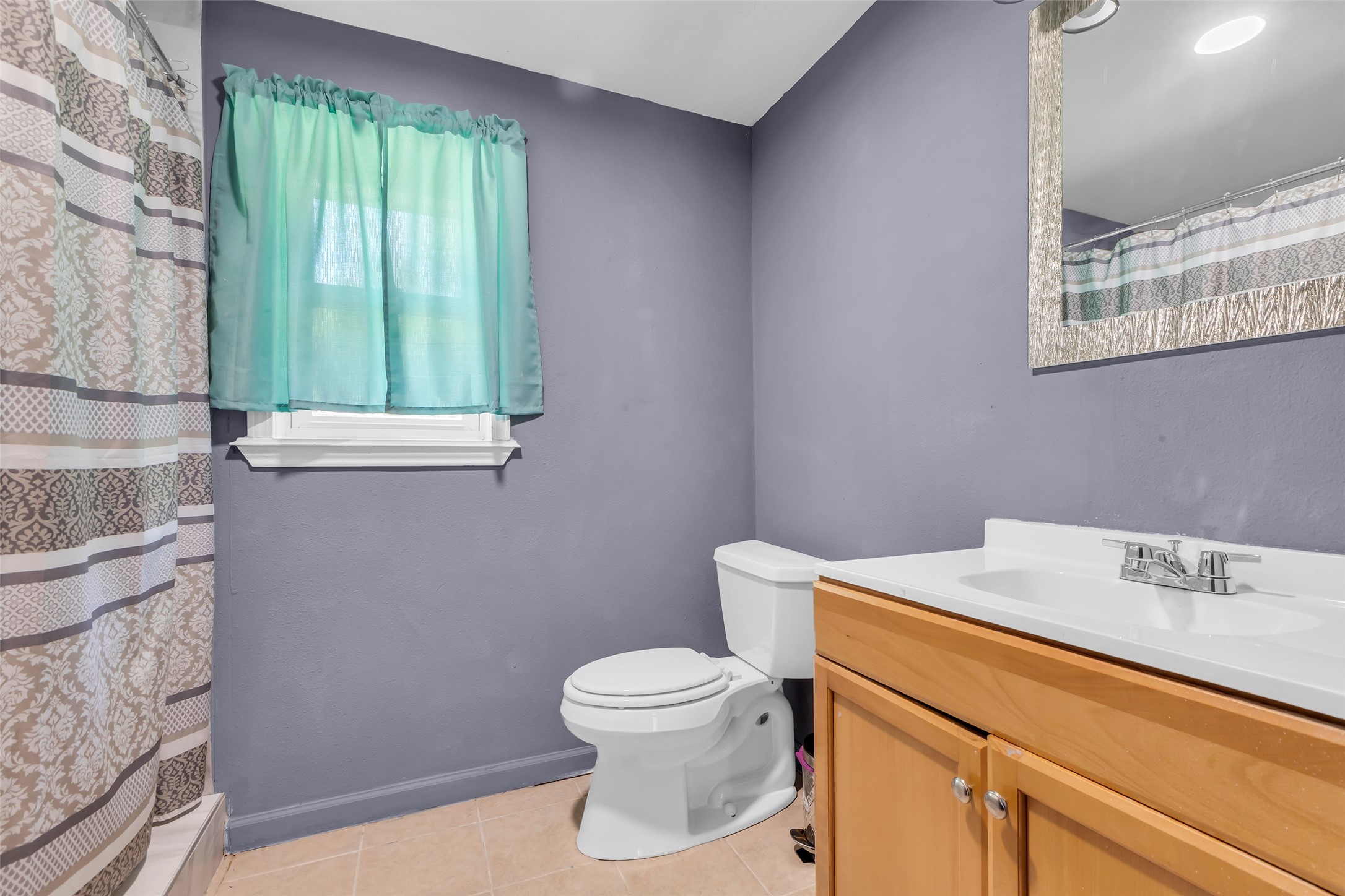 302 Channelview Drive Anahuac, TX 77514 - Photo 21 of 35 a bathroom with a toilet a sink and a window