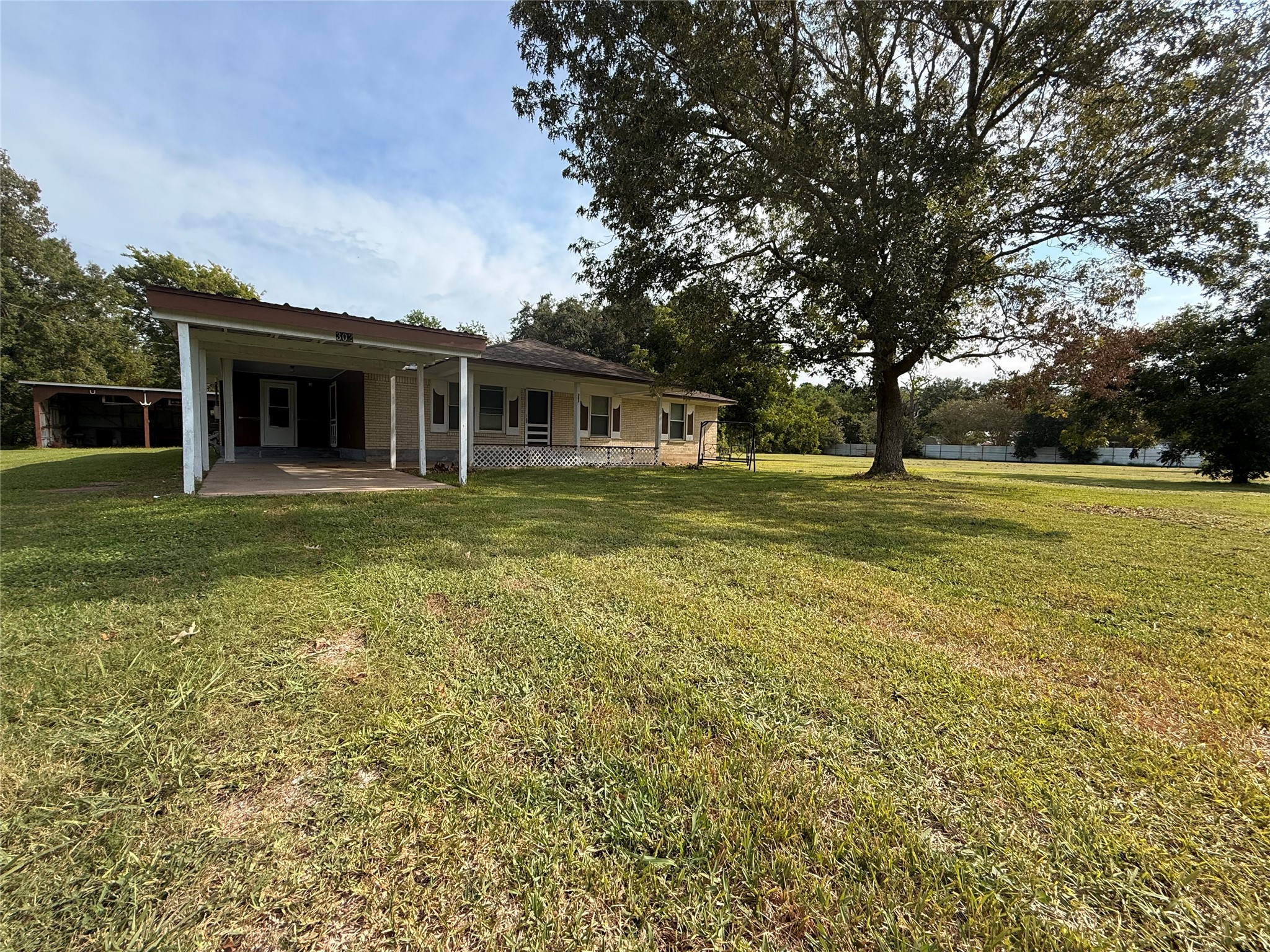 302 Channelview Drive Anahuac, TX 77514 - Photo 4 of 35 a view of a house with a big yard and large trees