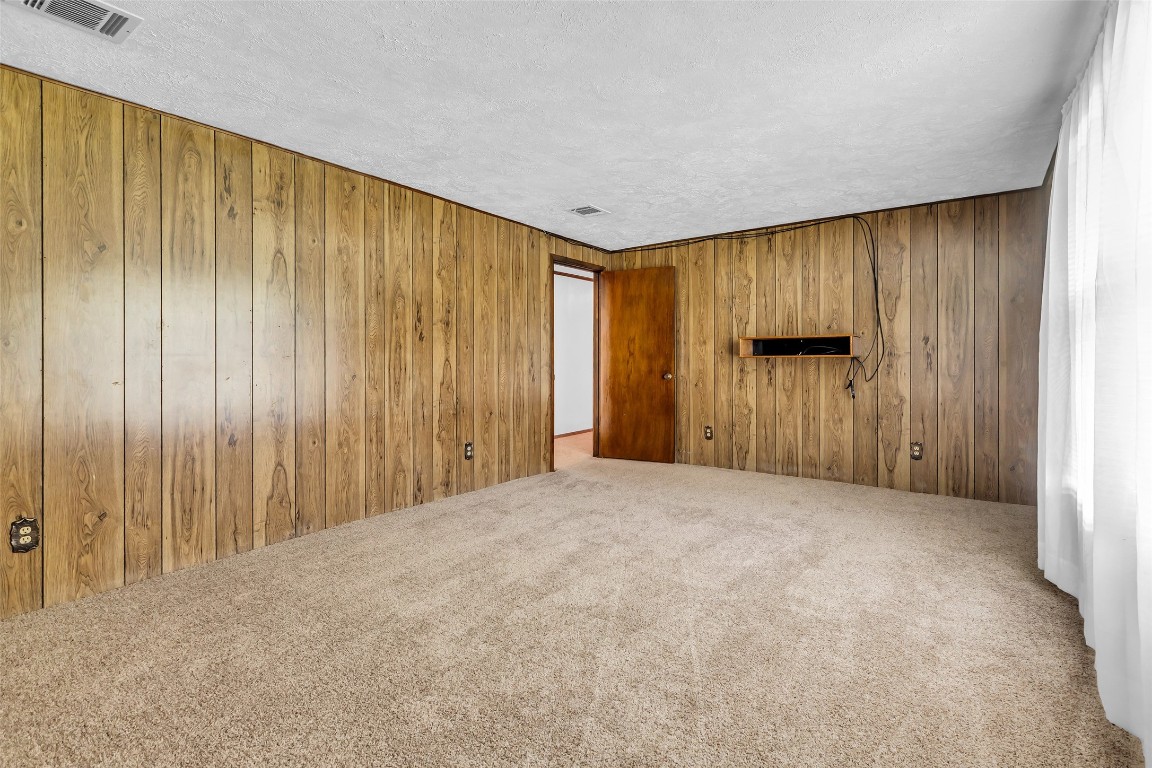 302 Channelview Drive Anahuac, TX 77514 - Photo 9 of 35 a view of an empty room with wooden walls