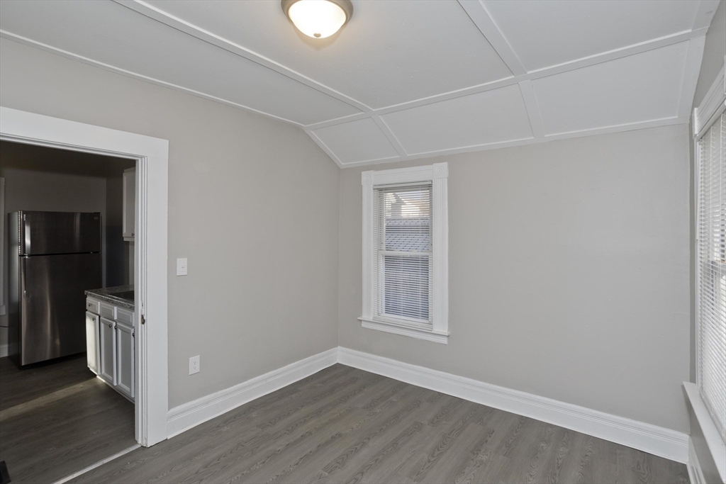 81 Hayden Avenue Springfield, MA 01109 - Photo 11 of 34 an empty room with wooden floor cabinet and windows