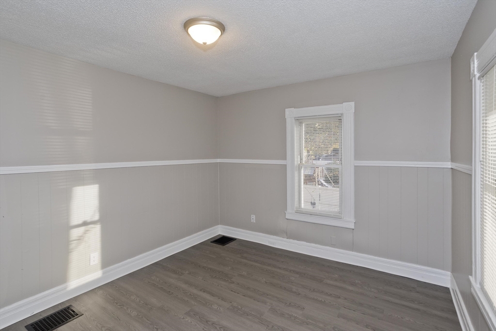 81 Hayden Avenue Springfield, MA 01109 - Photo 16 of 34 an empty room with wooden floor and windows