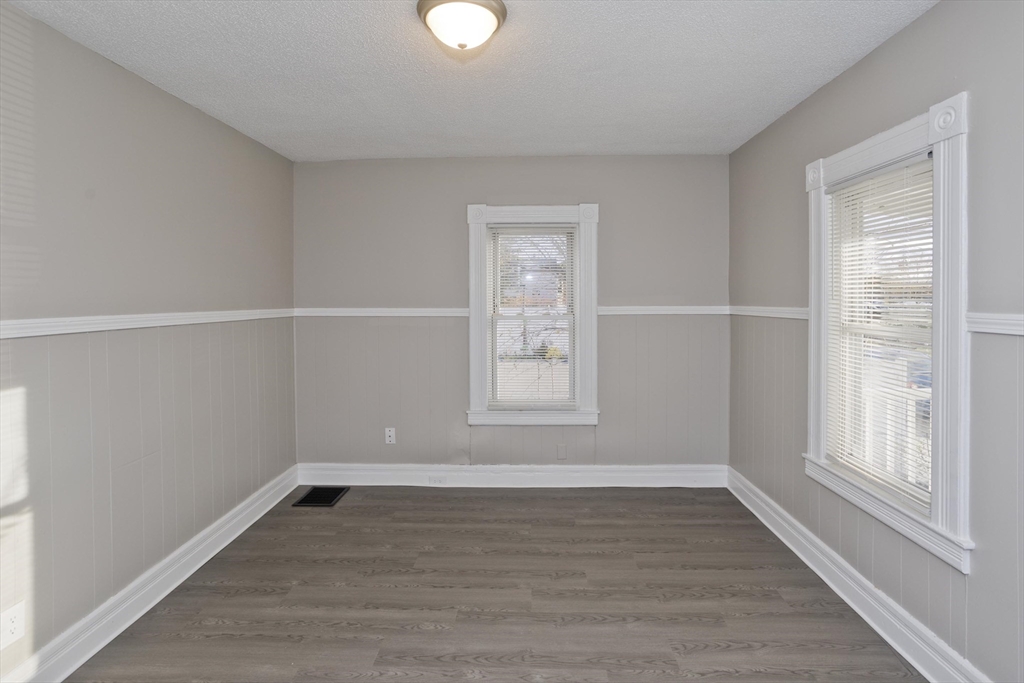 81 Hayden Avenue Springfield, MA 01109 - Photo 18 of 34 a view of an empty room with wooden floor and a window